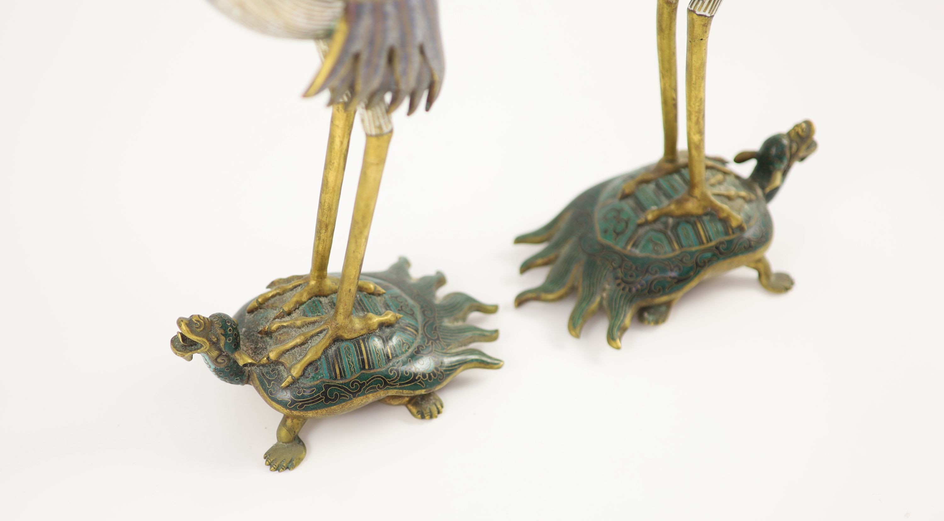 A pair of Chinese cloisonné enamel and gilt bronze ’crane’ candlesticks, early 20th century, 38cm high